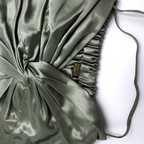 pistachio bonnet with a visible brand label on a white background