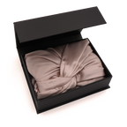 Pink bonnet in an open black box on a white background