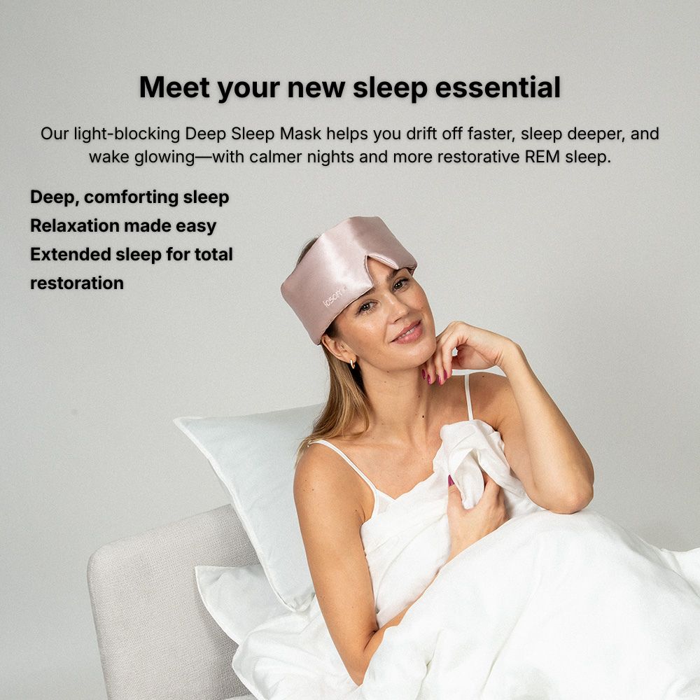 Woman wearing a pink sleep mask with text about its benefits on a light gray background