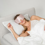Woman sleeping with a pink silk sleeping mask