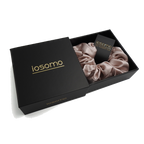 iosomo packaging with a pink scrunchie inside on a white background